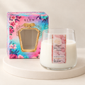 Pistachio Dream Perfumer candle in a rounded clear glass jar with rose label, cream wax and floral gift box on an ivory plinth