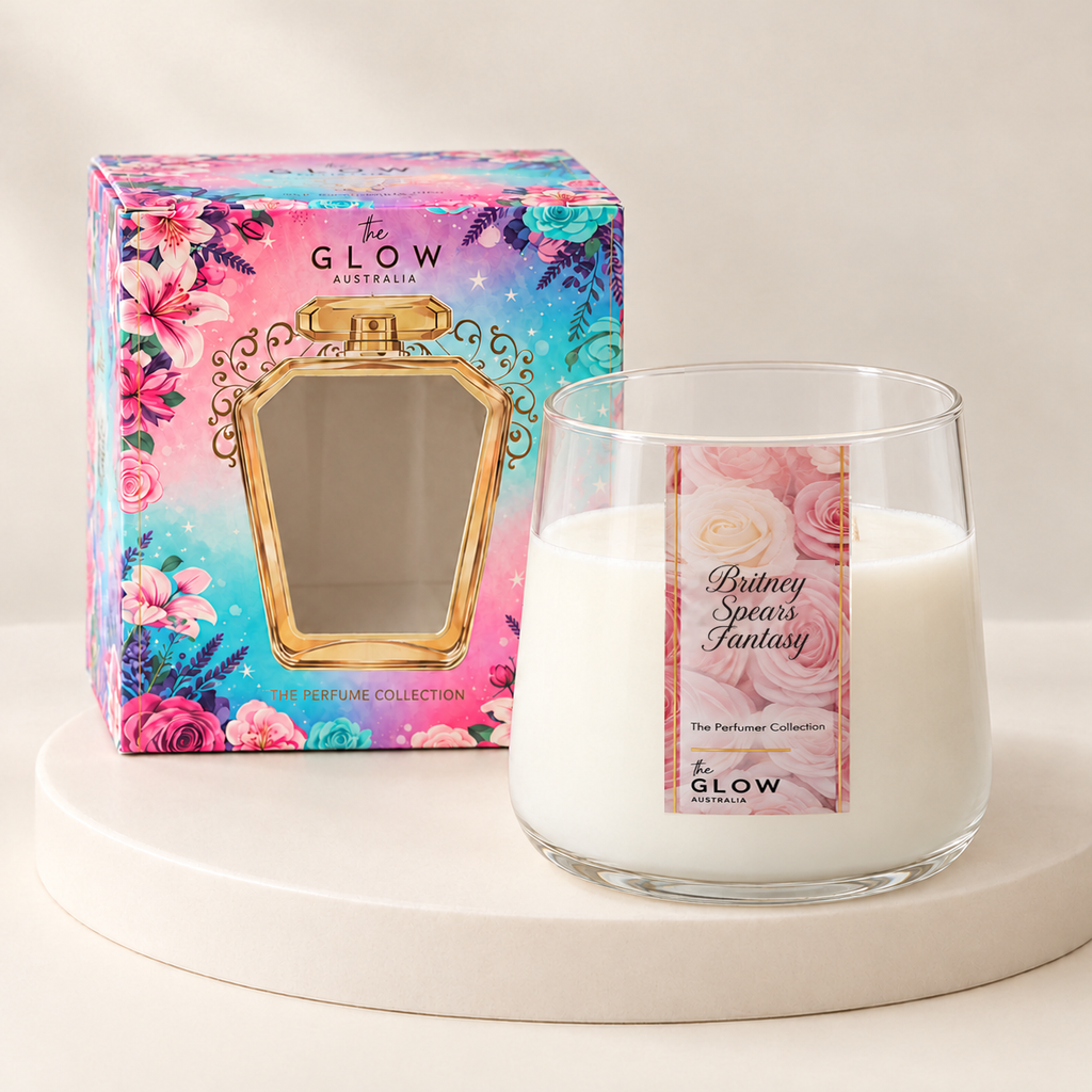 Sweet Darling Perfumer candle in a rounded clear glass jar with rose label, cream wax and floral gift box on an ivory plinth